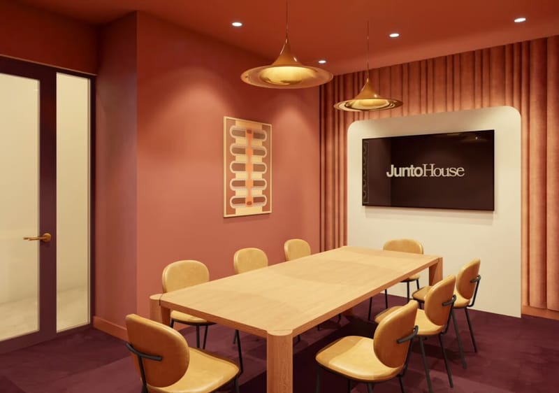 A meeting room at Junto House with a long wooden table.